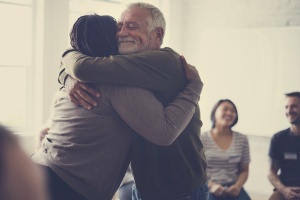 two people hugging in a Caregivers Support Group