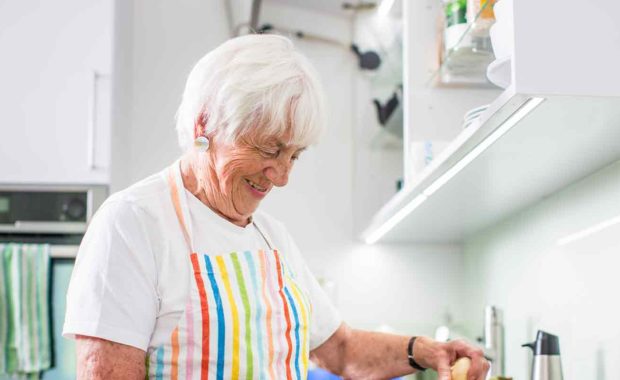 senior cooking at her home