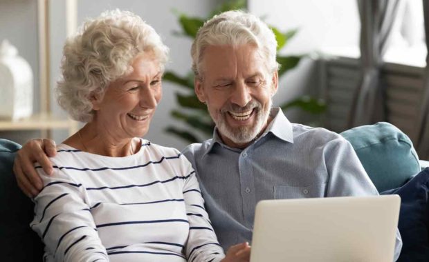 couple looking how to donate on computer