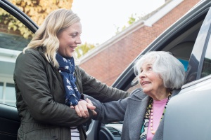 female driver helping women in a Senior Transportation