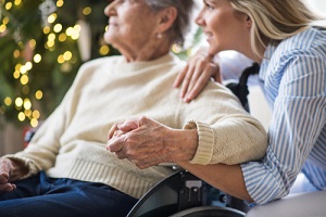 senior woman in wheelchair with a health visitor at her Senior Care Options