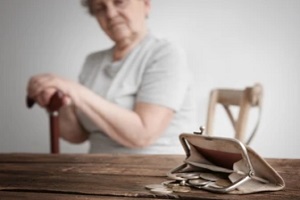 old lady with money on the table wondering should aging parents live with you
