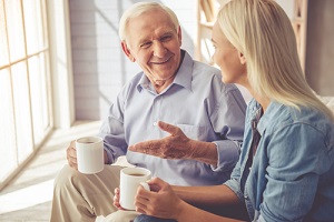 old man and beautiful young girl are drinking tea