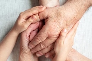 young hands holding old parents hands knowing parents getting older