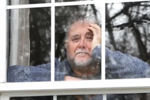 old man looking out of window