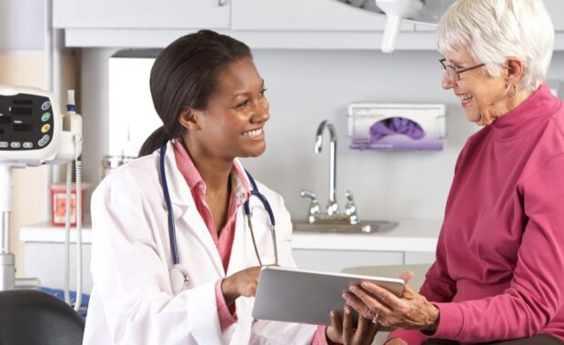 doctor discussing records with senior female patient