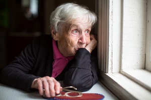 old women looking out of window while Aging In Place