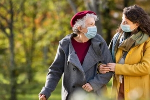 women taking aging parents for a walk