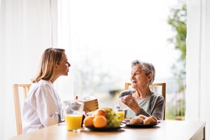 health visitor and a senior woman during home visit