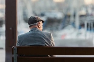 lonely senior man sitting outside