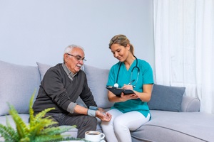 nurse visiting senior man for check up