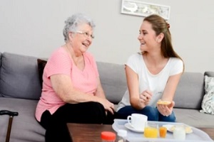 old lady and girl laughing with her friendly visitor program volunteer