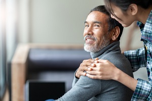 asian father with stylish short beard touching daughter's hand on shoulder