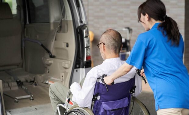 caregiver who puts an elderly person in a long-term care taxi