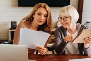 old lady and girl checking some legal documents