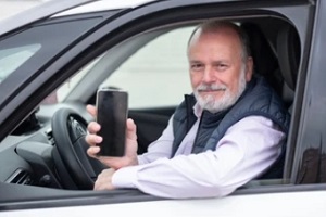 old man looking out of a car