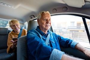 two senior in the back of a senior transportation car