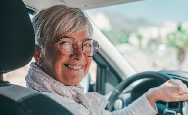 mature woman sitting relaxed in his newly bought car