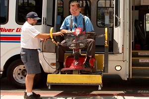 man in wheelchair using private senior transportation service
