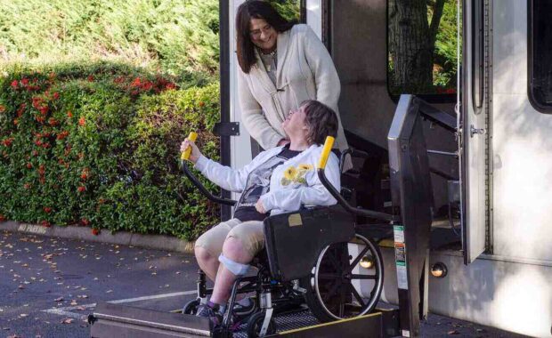 women helping old women on wheelchair