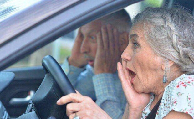 senior couple driving car