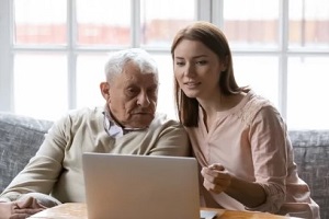 women and old man on laptop