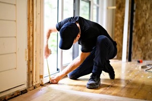 man fixing house door