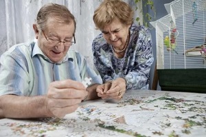 senior couple playing puzzle game