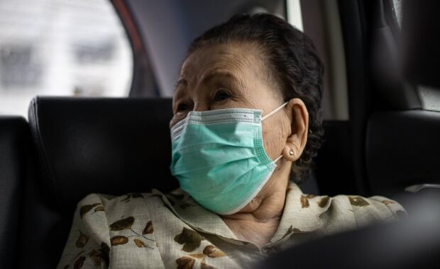 woman using protective face mask during traveling