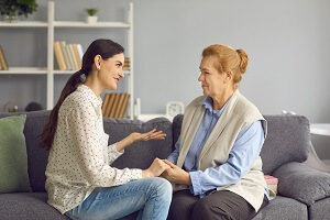 daughter talking to senior mother