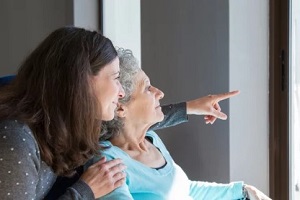 mother and old daughter looking out of window