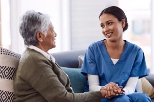 caregiver with old lady holding hands