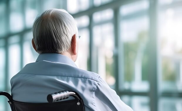 old man in wheelchair facing Northern VA senior hospital window