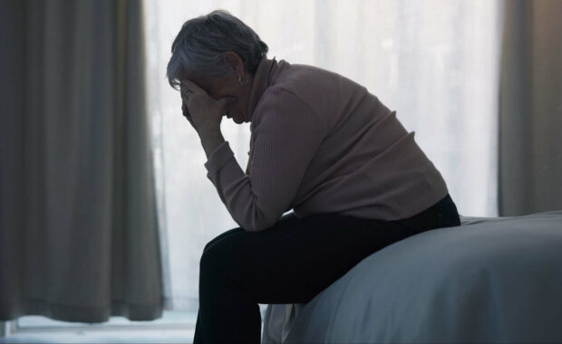 depression and sad old woman in bedroom with anxiety in Washington DC