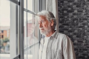 old man looking out of windows