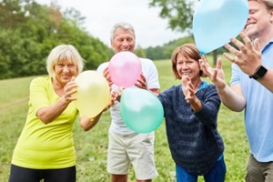 seniors play with colorful balloons