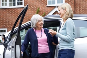 female neighbor giving senior woman a lift in car