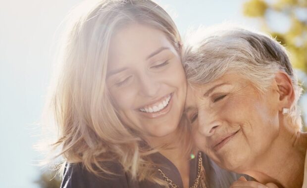 love or smile with a senior mother and daughter bonding outdoor together during a summer day