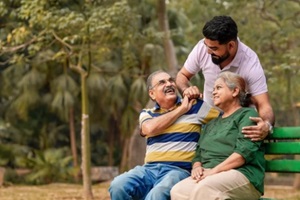 young Indian man with his parents at park