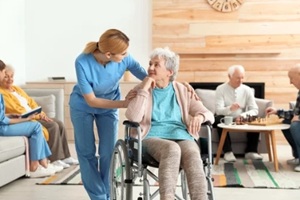 nurses assisting elderly people at retirement home