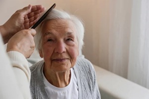 unrecognizable female expressing care towards an elderly lady