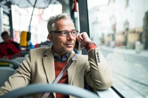 old man smiling and looking out of senior citizen transportation