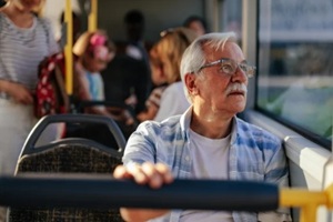 old man travelling in a bus