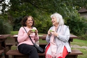 Smiling Old Women Sitting with Cups in Hand