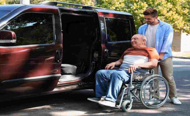 Young Senior Transport Service Provider Helping Elderly Man Get into Van