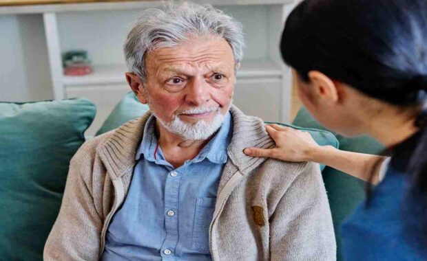 Female Caregiver Giving Support to Sad Lonely Senior
