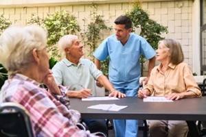 elderly individuals with caregiver engaging in a group activity at rehabilitation center
