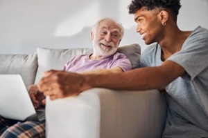 cheerful pensioner and a volunteer spending time together