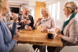 Cheerful Senior Friends Having Fun While Playing Cards