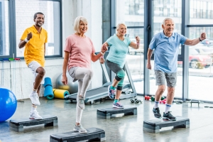 Smiling Seniors Doing Exercise in Gym
